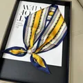 Elegant blue and yellow striped silk scarf featuring a stylish pearl magnetic buckle accessory - Fashion Elements