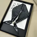 Elegant black and white polka dot neck scarf featuring a decorative white pearl bead - Black Polka Dot