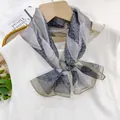 Elegant gray patterned thin gauze scarf ribbon accessory tied on a white blouse neck - Green Jade Ornament