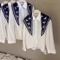 Detail view of a white blouse with a navy blue horse-patterned triangle scarf accessory - Pony Print (Pony Cotton Feel Triangle Scarf) / Navy Blue