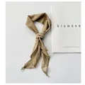 Detail shot of a textured khaki ramie thin scarf tied in a knot on white background - 110cm / Khaki