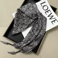 Elegant black and white paisley pattern triangular waist scarf for high-end styling. - Black and White Paisley with Tassels (Style 42)