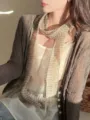 Close-up of a retro striped linen scarf styled with a grey knit cardigan. - Long Style / 185cm / Beige Striped