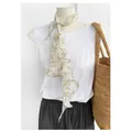 Floral print pure linen triangle scarf with contrast micro-curled edges on a mannequin - Light Yellow Grass Linen