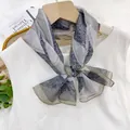 Elegant indigo paisley pattern long gauze scarf tied in a bow on a white silk top hanger - Green Jade Ornament