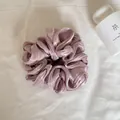 Detail van de gelaagde parelmoer satijnen textuur van de paarse oversized scrunchie - Parelmoer Roze