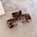 Detailed macro view of a large leopard print hair claw clip on textured white paper background - Square Claw Clip / Glossy Light Leopard