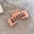 Detailed close-up view of a matte peach rectangular hair claw clip on textured paper. - Square Claw Clip / Matte Beige