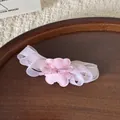 Detailed macro view of a pink multi-layer mesh bow hair clip with a cute bear ornament - Pink Bear Style (FJ160) / Pink Bear Hair Clip
