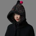 Detailed view of a black knitted balaclava hat with colorful speckles and pink pom-pom - Black