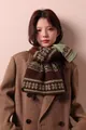 Detailed view of a cozy brown Fair Isle snowflake wool blend scarf on a model. - 170cm / Coffee Green
