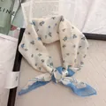 Close-up of vintage floral square scarf with delicate blue flowers on beige tray - 58cm / Blue Flower