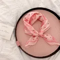 Detailed macro view of a pink cotton-linen scarf with red cherry and paisley patterns - 58cm / Pink Paisley Small Floral