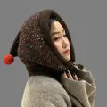 Detailed side view of winter knit balaclava hood with colorful speckles and red pompom - Coffee