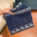 Navy blue knitted scarf with white reindeer and snowflake patterns for winter warmth. - Navy Blue