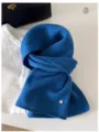 Close-up detail of soft blue 100% wool knit scarf styled with classic fashion props - 144cm / Pure Blue