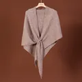 Macro view of the elegant textured wool blend knit and the central cross-knot design. - Oatmeal