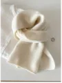 Close-up detail of a soft cream 100% wool knit scarf styled on a white linen shirt - 144cm / Vanilla White