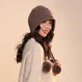 Detailed view of a brown wool pumpkin style beanie hat with decorative pompom accents - One Size / Coffee