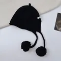Cozy black wool knitted hat with cute ear flaps and large pom-poms for winter style - One Size / Black