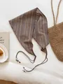Detailed close-up of a retro striped triangle scarf with elegant beaded tie straps. - Chestnut Colorful Striped