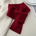 Detailed macro view of dark red knitted cross-over neck warmer scarf showing soft wool texture - Criss Cross Halter / New Year Red
