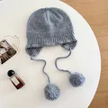 Detailed macro view of a gray 100% wool knit beanie with soft pom-poms and earflaps - M (56-58cm) / Light Gray