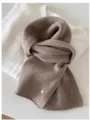 Close-up of soft taupe 100% wool fine knit vintage scarf with circular metal tag - 144cm / Oatmeal