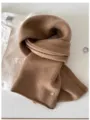 Detailed macro view showing the soft texture of a 100% wool fine knit scarf in camel brown - 144cm / Classic Camel