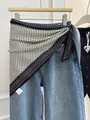 Chic black and white polka dot triangle scarf tied over blue denim jeans for styling - White Speckled