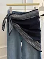 Navy blue paisley printed triangle silk scarf styled on denim jeans as waist accessory - Black Paisley with Border