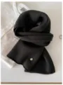 Close-up detail of soft 100% wool fine knit scarf in charcoal black with gold metal tag - 144cm / Moss Green