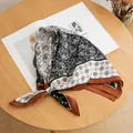 Detail view of a French retro silk square scarf with rose and floral patterns on wood - Square Scarf / Black and White Rose
