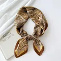 Detailed view of a retro paisley silk scarf featuring elegant brown and gold floral patterns - Square Scarf / Champagne Paisley (Satin Paisley)