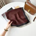 Detailed macro view of a burgundy square scarf with a geometric pattern and border - RZ7072-Dot Coffee