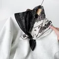 Close-up of a black and white paisley cotton linen square scarf on a sweatshirt - RZ6531 - Black