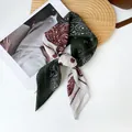 Close-up view of elegant dark green paisley print scarf with a soft cotton-linen texture - RZ6531 - Green