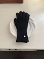 Elegant black knitted wool gloves with circular metal logo tag for women winter warmth - Gloves / Black