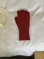 Cozy dark red knitted winter glove with a stylish oval metal brand tag on a white fabric - Gloves Only / Red