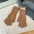 Macro detail of high-quality brown 100% Merino wool knitted gloves for winter warmth. - One Size / Camel