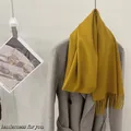 Soft mustard yellow 100% wool solid color scarf with fringe detail draped on grey coat - Ginger Yellow / 185cm