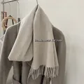 Détail de la texture en laine douce et des franges élégantes d'une écharpe beige. - Beige Abricot / 185cm