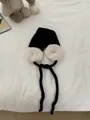 Stylish cozy black and white plush earmuff hat with long ties for winter warmth and comfort - One Size / Black