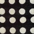Close-up of thick chenille jacquard fabric with vintage white polka dots on black - 145cm Wide / Black