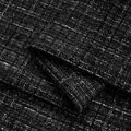Close-up of premium black tweed fabric with shiny metallic silver thread for clothing - No. 13 Dark Gray