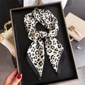 Detailed close-up of a French retro leopard print silk scarf tied as an elegant belt accessory - Square Scarf / Off-white Leopard Print
