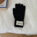 Warm solid black winter knitted gloves featuring a decorative white woven patch detail - One Size / Black