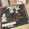 Detailed macro view of vintage brown leaf pattern jacquard fabric for luxury sofas and curtains. - Sofa Fabric / 中古繁枝主图色