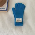 Warm solid blue knitted gloves for winter featuring a stylish decorative woven label. - One Size / Teal