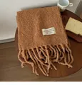 Thick caramel wool scarf with tassels and decorative brand label for cozy winter warmth. - Camel